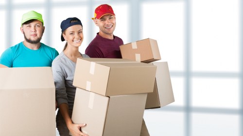 Movers handling furniture during a flat removal in Haringey