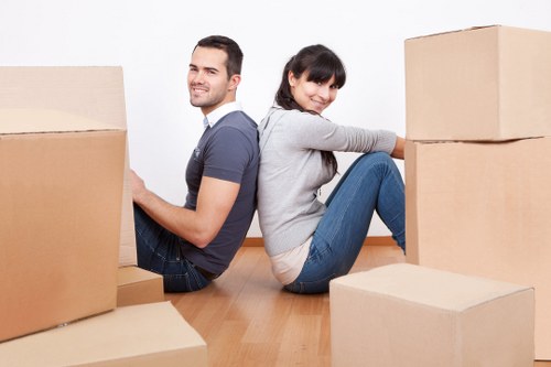 Crew separating cardboard, metal, and reusable furniture for recycling