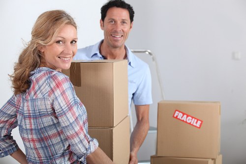 Removal staff using careful lifting techniques during a house move