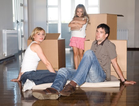Removal team handling furniture in a Haringey flat